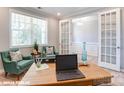 Comfortable office space with French doors, green chairs, and natural light at 9842 Quercus Ln, Huntersville, NC 28078