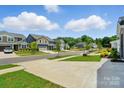 Street view showcasing houses and neighborhood, plus sidewalks and green spaces at 9842 Quercus Ln, Huntersville, NC 28078