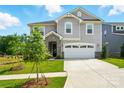 Charming two-story home boasts a two-car garage, stone accents, manicured lawn, and inviting curb appeal at 9934 Cask Way, Huntersville, NC 28078