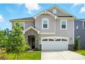 Charming two-story home boasts a two-car garage, stone accents, manicured lawn, and inviting curb appeal at 9934 Cask Way, Huntersville, NC 28078