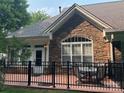 Back patio featuring stone accents and a wrought iron fence at 10875 Casetta Dr, Matthews, NC 28105