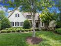 Charming exterior elevation of home with manicured landscaping and mature trees, providing a warm and inviting curb appeal at 1103 Mapesbury Ln, Waxhaw, NC 28173