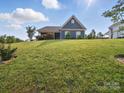 Blue house is nestled on a lush green lawn, perfect for outdoor enjoyment at 11225 Island View Ln, Lancaster, SC 29720