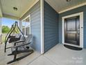 Inviting covered front porch with a swing and chairs for relaxing at 11225 Island View Ln, Lancaster, SC 29720
