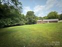 Expansive backyard featuring lush greenery and mature trees provides privacy and a connection with nature at 117 Lincoln Village Dr, Statesville, NC 28677