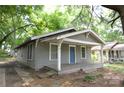 Single-story home with a covered front porch and classic architectural details at 1216 Mountain Ave, Gastonia, NC 28052