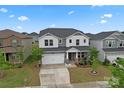 Two-story home with a two-car garage, landscaped yard, and neighborhood view at 12536 Stoneybrook Pkwy, Huntersville, NC 28078
