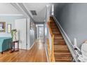 Bright hallway featuring hardwood floors, painted walls, and a motorized chair lift at 126 Rocky Trail Ct, Fort Mill, SC 29715