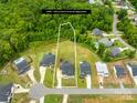 Aerial view showcasing property lines, a spacious lot surrounded by lush greenery, and neighboring houses at 126 Still Creek Dr, Mooresville, NC 28115