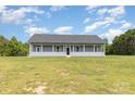 Exterior of a one-story home with a long porch and a large lawn at 135 Waycross Dr, Rockwell, NC 28110