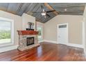 Living room with a metal ceiling, hardwood floors, and a stone fireplace at 135 Waycross Dr, Rockwell, NC 28110