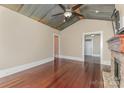 Large living room with a metal ceiling, hardwood floors, and a stone fireplace at 135 Waycross Dr, Rockwell, NC 28110