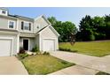 Attractive townhome showcasing meticulous landscaping and an attached one-car garage for added convenience and aesthetic charm at 1365 Eagle Claw Dr, Kannapolis, NC 28083