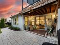 Outdoor patio with comfortable seating and a view into the home's kitchen at 14128 Morningate St, Huntersville, NC 28078