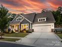 Beautiful home with a well-manicured lawn, long driveway, and a two-car garage at 14128 Morningate St, Huntersville, NC 28078