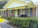 Inviting front porch with bench seating and manicured hedges at 1460 Legion Rd, Fort Mill, SC 29715