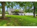 View of the house, showing the front yard, a mature shade tree and rope swing at 1621 California Rd, York, SC 29745
