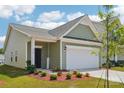 Delightful one-story house with a welcoming entrance, featuring a two-car garage and verdant front yard at 1770 Troon Dr, Salisbury, NC 28144