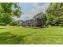 Spacious home with a well-manicured lawn and mature trees offering plenty of shade at 1867 Shannon Dr, Conover, NC 28613