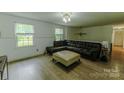 Comfortable living room featuring hardwood floors and abundant natural light through large windows at 1867 Shannon Dr, Conover, NC 28613