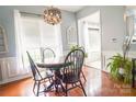 Cozy dining room featuring a round table, classic chandelier, and natural light from the large window at 19182 Mallard Dr, Fort Mill, SC 29707