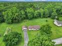 Expansive aerial view showcases the house and its verdant surroundings, nestled among lush trees and green lawns at 2084 Old Evans Cir, Lancaster, SC 29720