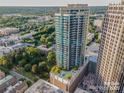 An aerial shot shows the building's unique rooftop pool and its relationship to nearby buildings at 210 N Church St # 2807, Charlotte, NC 28202