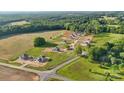 Aerial shot of a new housing development surrounded by lush green forests and open fields at 21063 Running Creek Dr # 11, Locust, NC 28097