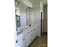 Elegant bathroom featuring double sinks, white cabinets, and modern fixtures at 2199 Catawba Trace Dr, Catawba, NC 28609