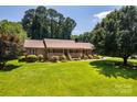 Brick home with well-maintained lawn and mature trees offers great curb appeal at 2209 Cardinal Loop, Stanley, NC 28164