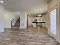Open concept view of the living room and kitchen featuring modern finishes and a staircase at 231 Brook Se Ave, Concord, NC 28025