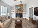 Inviting living room with a striking brick fireplace and stylish decor at 2316 Woodfield Cir, Gastonia, NC 28056
