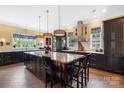 Spacious kitchen featuring dark cabinets, large center island, stainless steel appliances and unique light fixtures at 2354 Valelake Rd, York, SC 29745