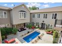 Beautiful outdoor courtyard featuring a sparkling pool with cozy seating, perfect for relaxing and entertaining at 2354 Valelake Rd, York, SC 29745