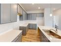 The kitchen has shaker style gray cabinets, bright countertops and a modern single bowl sink at 2547 Ruby Dixon Crossing Dr # 17, Gastonia, NC 28056