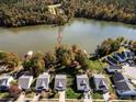 Aerial view of waterfront homes with boat docks on a lake surrounded by colorful trees at 25566 Seagull Dr, Lancaster, SC 29720