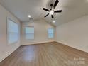Spacious bedroom featuring light wood floors, recessed lighting, ceiling fan, and natural light at 2620 Poplar Cove Nw Dr, Concord, NC 28027