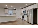 Bright kitchen with stainless steel appliances, an island, and white cabinets at 2620 Poplar Cove Nw Dr, Concord, NC 28027