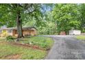 A large, well-maintained yard showcases a lovely brick home with mature trees at 2631 Ivey Church Rd, Lincolnton, NC 28092