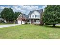 Charming two-story brick home with a covered front porch and a well manicured front lawn at 2779 Touchstone Cir, Newton, NC 28658