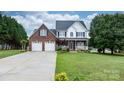 Charming two-story brick home with a covered front porch and manicured lawn offers curb appeal at 2779 Touchstone Cir, Newton, NC 28658