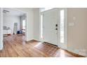 Bright entryway with wood floors, showcasing the front door and access to other rooms at 3725 Leela Palace Way, Fort Mill, SC 29708