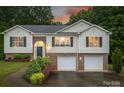 Charming two-story home featuring a brick facade, vinyl siding, and an attached two-car garage at 4059 Caitlins Way, Hickory, NC 28602