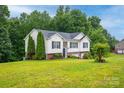 Well-maintained two-story home with vinyl siding, a lush lawn, and mature trees in a quiet neighborhood at 4059 Caitlins Way, Hickory, NC 28602