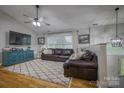 Bright living room with hardwood floors, vaulted ceiling, and a comfortable seating area with a large window at 4059 Caitlins Way, Hickory, NC 28602