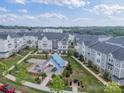 An attractive aerial view of a neighborhood highlighting the common area with covered seating and fire pit at 4439 Millennium Ave, Charlotte, NC 28217