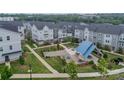 A beautiful aerial view of a neighborhood featuring a central community area with green spaces and seating at 4439 Millennium Ave, Charlotte, NC 28217