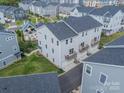 An impressive aerial view showcases townhomes with balconies overlooking a central common area with green space at 4439 Millennium Ave, Charlotte, NC 28217