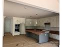Spacious kitchen features white cabinets, a large island, and stainless steel appliances at 4622 Serenity Woods Ct, Charlotte, NC 28216