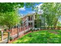 Inviting condo exterior with red railings, lush greenery, and convenient walkway access at 502 Lake Club Dr, Rock Hill, SC 29732